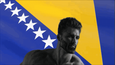 A Man With A Beard Is Standing In Front Of A Flag With White Stars GIF