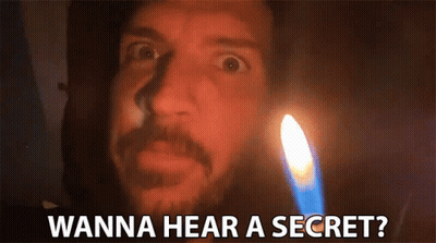 A Man With A Beard Is Standing In Front Of A Lit Candle And Says Wanna Hear A Secret ? GIF