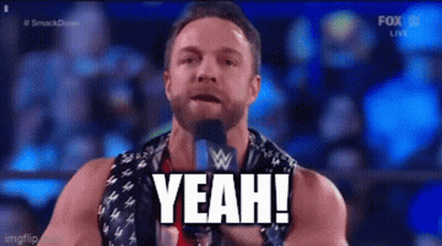 A Man With A Beard Is Standing In Front Of A Microphone And Saying Yeah . GIF