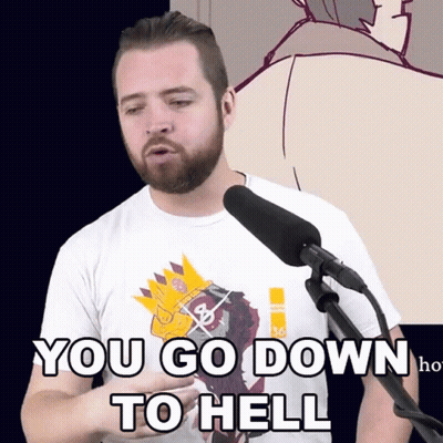 A Man With A Beard Is Standing In Front Of A Microphone With The Words You Go Down To Hell Written On His Shirt GIF