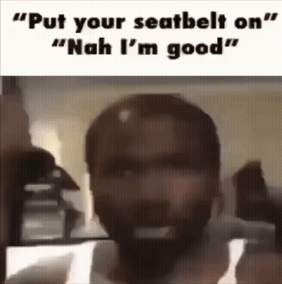 A Man With A Beard Is Standing In Front Of A Mirror With The Words `` Put Your Seatbelt On '' Written On It . GIF