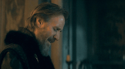 A Man With A Beard Is Standing In Front Of A Poster That Says Is That What You Think GIF