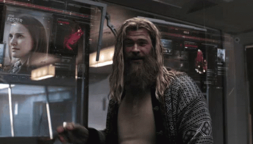 A Man With A Beard Is Standing In Front Of A Screen With Jane Foster Written On It GIF