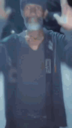 A Man With A Beard Is Standing In Front Of A Sign That Says " Expansion " GIF