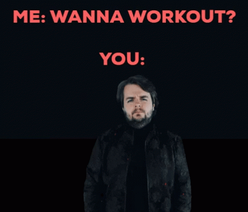 A Man With A Beard Is Standing In Front Of A Sign That Says " Me Wanna Workout " GIF