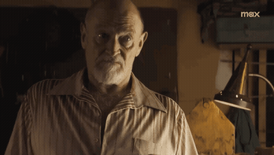 A Man With A Beard Is Standing In Front Of A Sign That Says Mox GIF