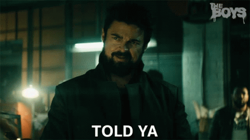 A Man With A Beard Is Standing In Front Of A Sign That Says The Boys GIF