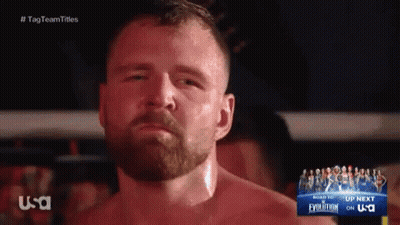 A Man With A Beard Is Standing In Front Of A Sign That Says Usa GIF