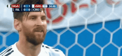 A Man With A Beard Is Standing In Front Of A Soccer Goal During A Game . GIF