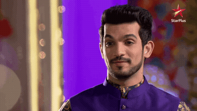 A Man With A Beard Is Standing In Front Of A Star Plus Sign GIF