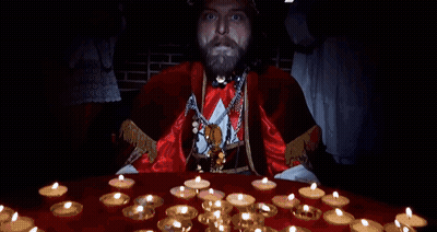 A Man With A Beard Is Standing In Front Of A Table With Candles And Says I Am The Pope Of Dope GIF