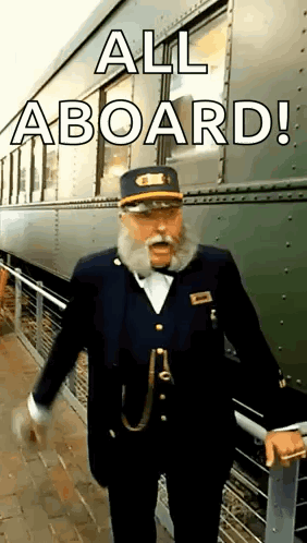 A Man With A Beard Is Standing In Front Of A Train . GIF