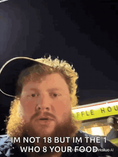 A Man With A Beard Is Standing In Front Of A Waffle House .. GIF
