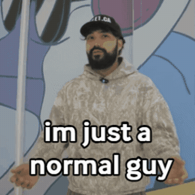 A Man With A Beard Is Standing In Front Of A Wall And Says " Im Just A Normal Guy " GIF