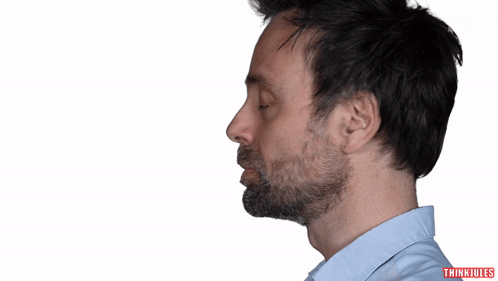 A Man With A Beard Is Standing In Front Of A White Background That Says Tort GIF