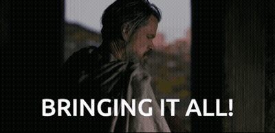 A Man With A Beard Is Standing In Front Of A Window And Says Bringing It All . GIF