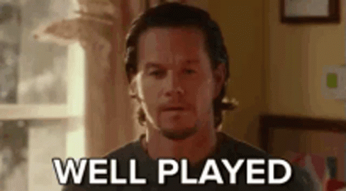 A Man With A Beard Is Standing In Front Of A Window And Says `` Well Played '' . GIF