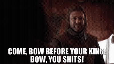 A Man With A Beard Is Standing In Front Of A Window And Talking To Another Man In A Room . GIF