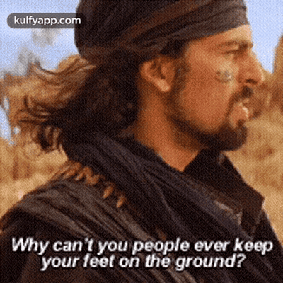 A Man With A Beard Is Standing In The Desert And Says Why Can 'T You People Ever Keep Your Feet On The Ground GIF