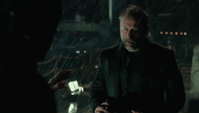 A Man With A Beard Is Standing In The Rain With His Mouth Open . GIF