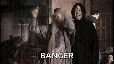 A Man With A Beard Is Standing Next To A Man With A Beard In A Room . GIF