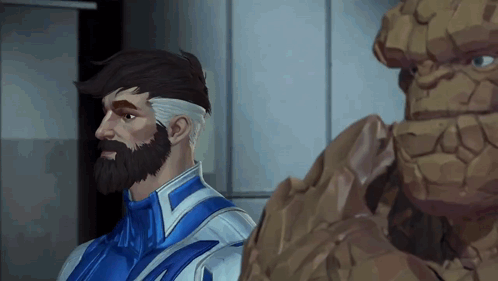 A Man With A Beard Is Standing Next To A Rock GIF
