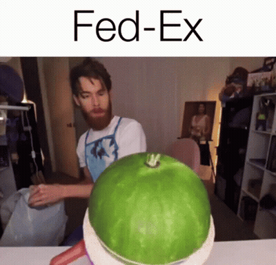 A Man With A Beard Is Standing Next To A Watermelon That Says Fed-Ex On It GIF