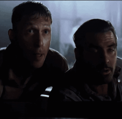 A Man With A Beard Is Standing Next To Another Man GIF