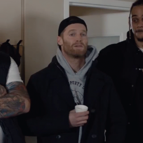 A Man With A Beard Is Standing Next To Another Man With The Word Potato On It GIF