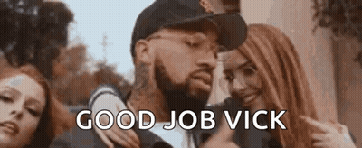 A Man With A Beard Is Standing Next To Two Women And Giving A Thumbs Up Sign . GIF