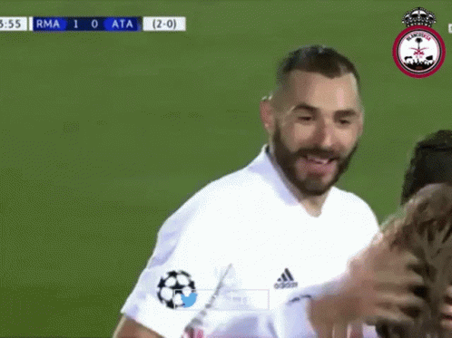 A Man With A Beard Is Standing On A Soccer Field With His Hands On His Face . GIF