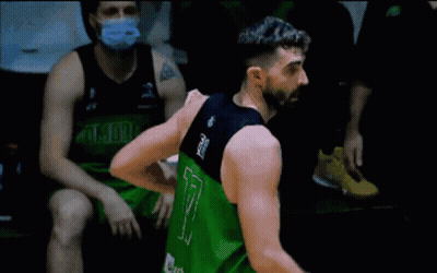 A Man With A Beard Is Standing On A Trampoline With A Towel Around His Waist . GIF