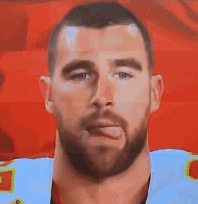 A Man With A Beard Is Sticking His Tongue Out In A Close Up Of His Face . GIF