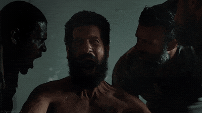 A Man With A Beard Is Surrounded By Two Other Men With Their Mouths Open GIF