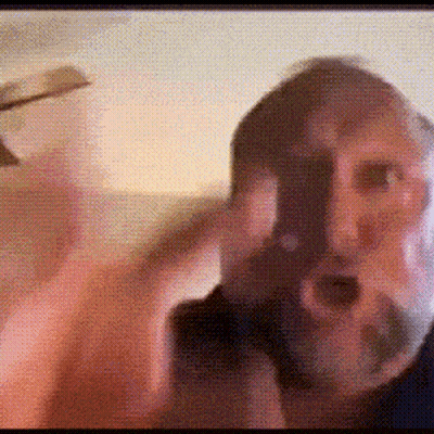 A Man With A Beard Is Taking A Picture Of Himself With His Cell Phone . GIF
