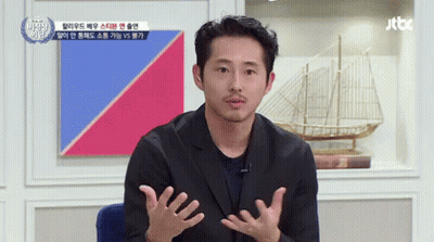 A Man With A Beard Is Talking In Front Of A Jtbc Sign GIF