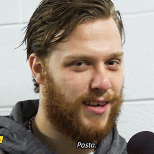 A Man With A Beard Is Talking Into A Microphone And The Word Pasta Is On His Face GIF