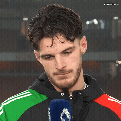 A Man With A Beard Is Talking Into A Microphone With The Word Canirove On The Bottom Right GIF