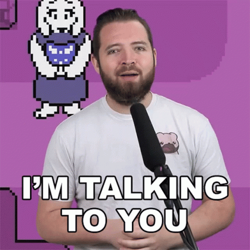 A Man With A Beard Is Talking Into A Microphone With The Words I 'M Talking To You Below Him GIF