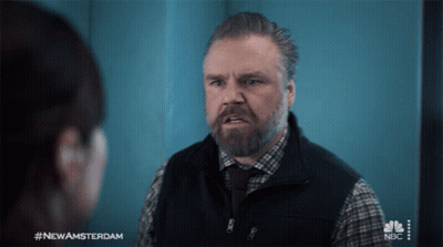 A Man With A Beard Is Talking To A Woman With #Newamsterdam On The Bottom GIF