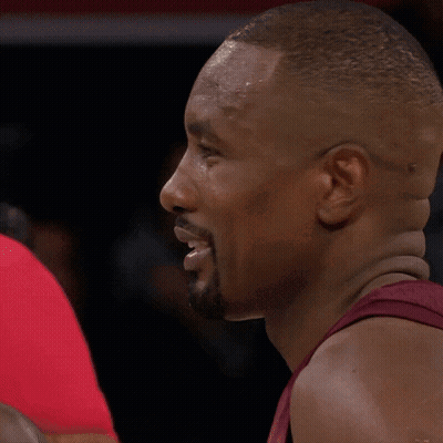 A Man With A Beard Is Talking To Another Man In A Red Shirt GIF