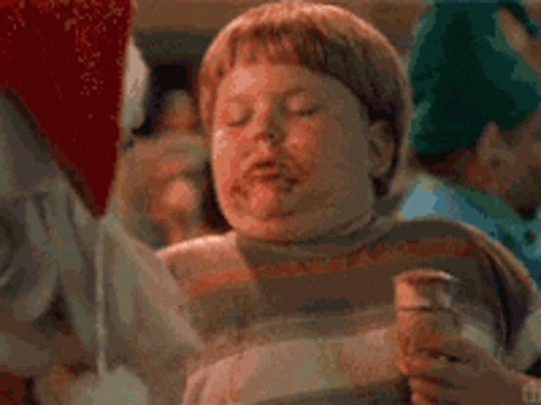 A Man With A Beard Is Talking To Another Man In A Santa Costume GIF
