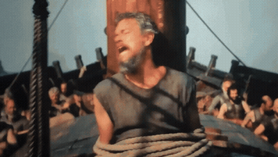 A Man With A Beard Is Tied To A Rope On A Ship GIF