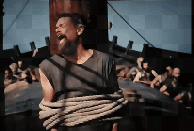 A Man With A Beard Is Tied Up With A Rope And Screaming GIF