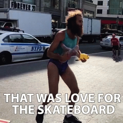 A Man With A Beard Is Walking Down A Street With The Words That Was Love For The Skateboard Below Him GIF