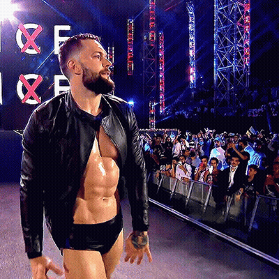A Man With A Beard Is Walking In Front Of A Sign That Says X GIF