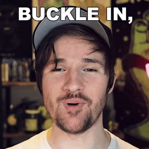 A Man With A Beard Is Wearing A Baseball Cap And Says " Buckle In " GIF