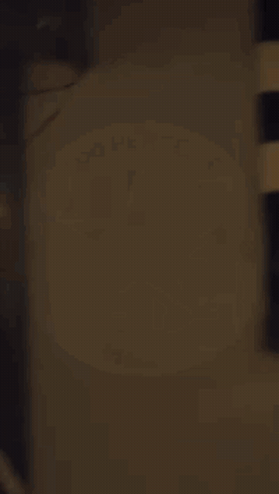 A Man With A Beard Is Wearing A Black And White Striped Shirt And Holding A Spoon . GIF