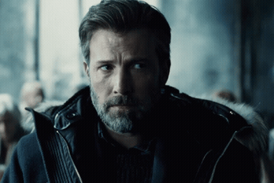 A Man With A Beard Is Wearing A Black Coat With A Fur Hood GIF