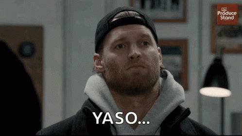 A Man With A Beard Is Wearing A Black Hat And A Gray Sweatshirt And Says Yaso GIF